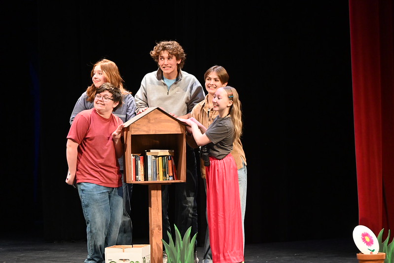 COMMUNITY. Ferguson's play ended with all residents of the street repairing the little library together. 