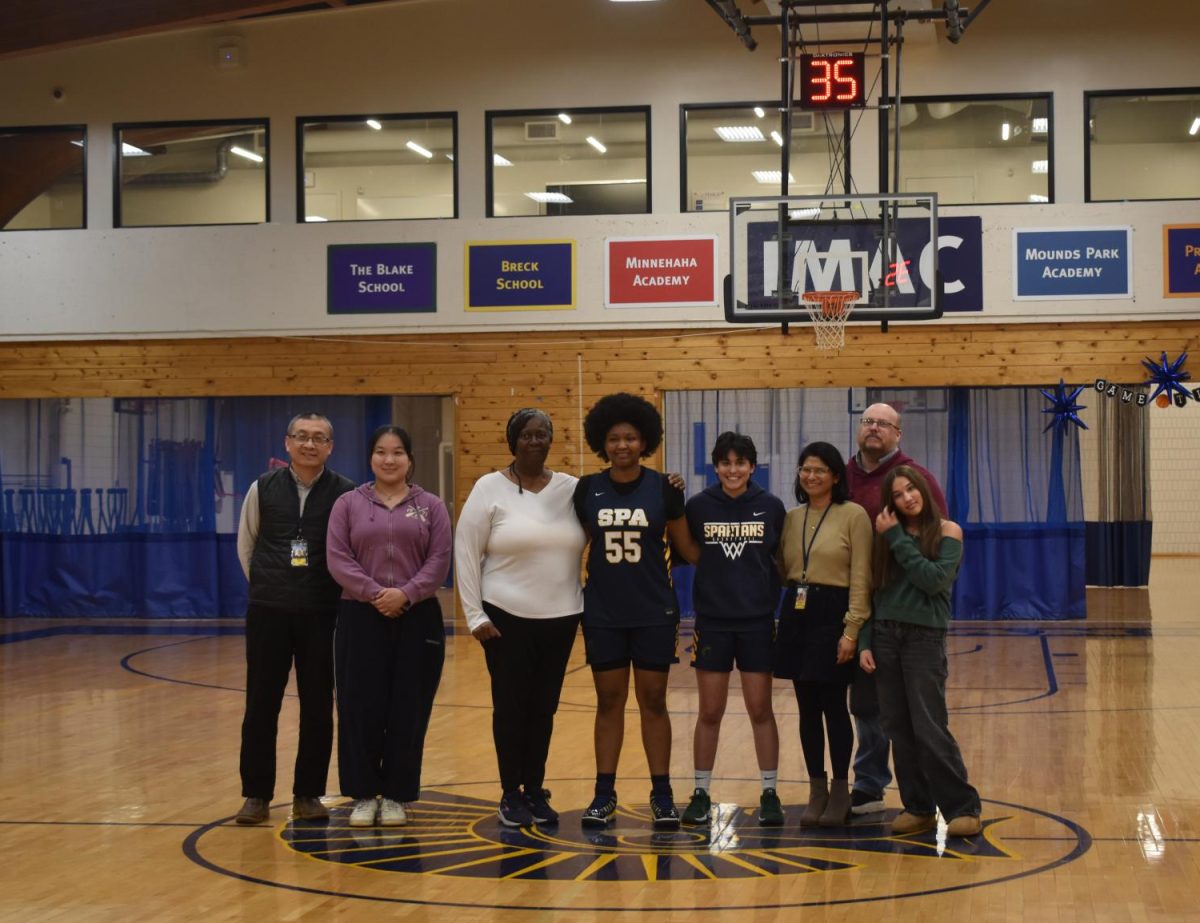LAST HURRAH. Before the game, seniors Nijah Johnson, Zimo Xie and Devy Nelson stand in the center of the gym with their families for photos and for a speech for each of the three. They get ready to play for senior night in their last season.