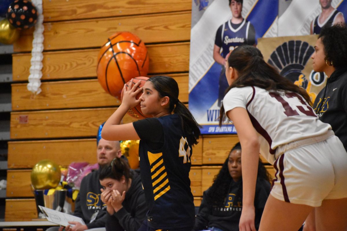 TEAMWORK. Ninth grader Zoya Jameel looks around for a teammate to pass the ball to.