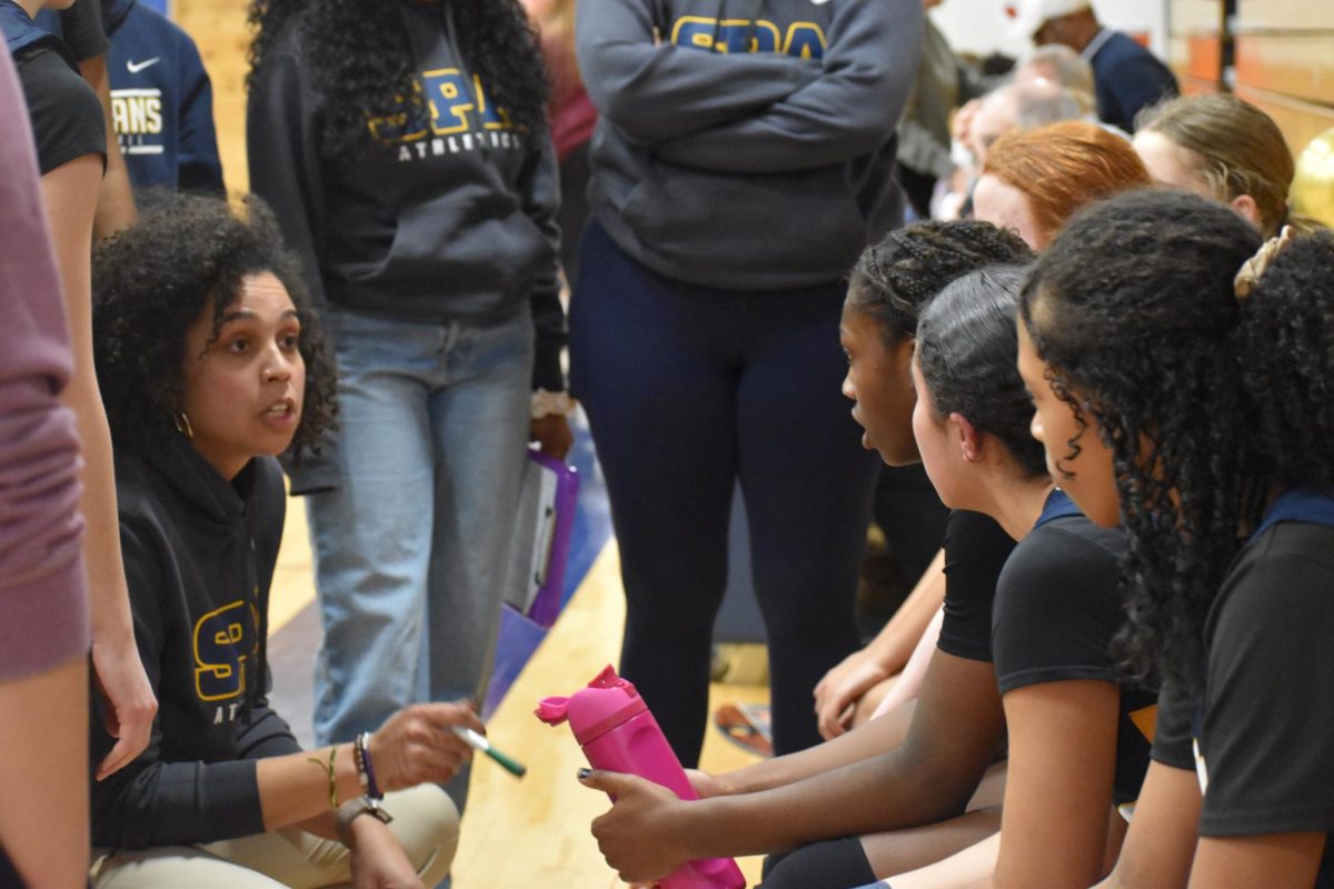 PLAYS. Head varsity coach, Natalye James, directs the team in plays and encouraging words when down 3 points in the final minutes of the game.