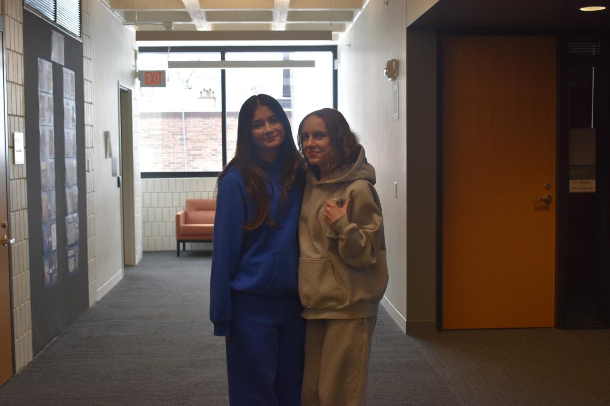CONTRASTING COLORS. Seniors Reina Heidkamp and Lilly Spurgeon wore opposite colors of blue and white.