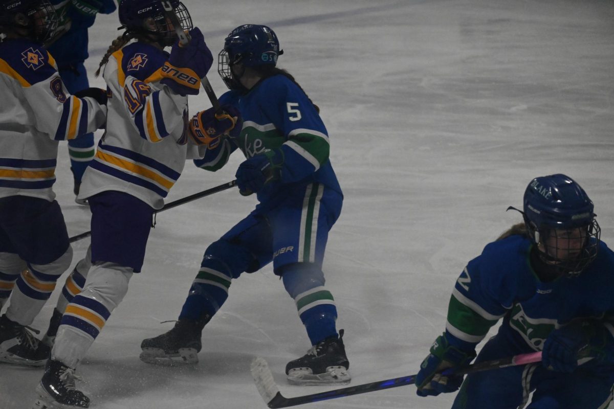 CLASH. Blake and CDH players collide by the walls fighting for the puck.
