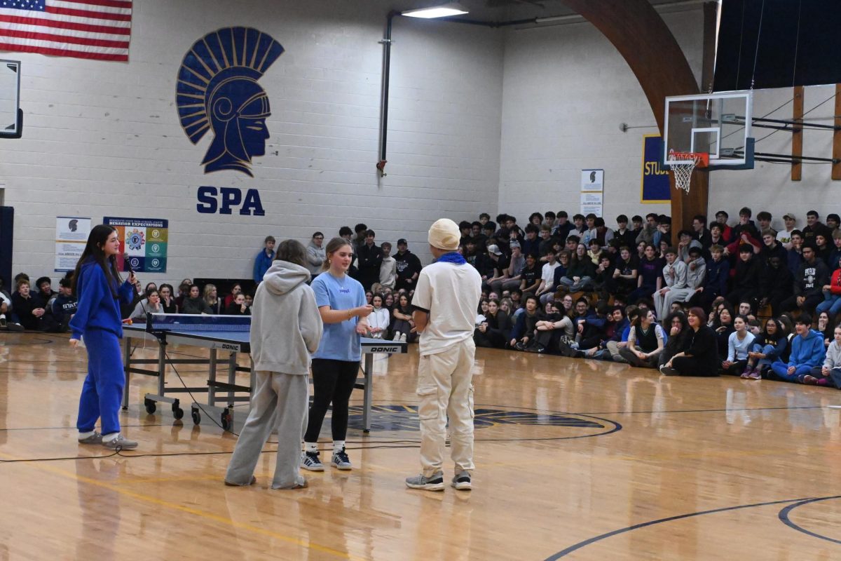 FINALS. Ninth Grader Ruby Rush and senior Ethan He compete in the finals of the rock paper scissors champion and 100 house cup points.