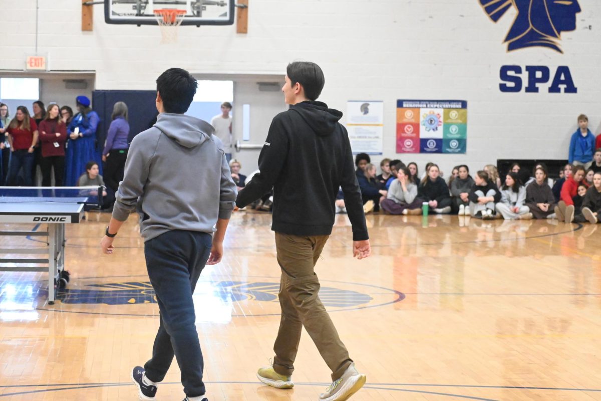 WALKOUT. Sophomores Winston Arvidson and Daren Hull cruise towards the ping pong table for the championship match.