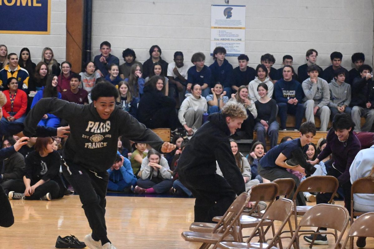 GET THERE. Senior Ezra Cunningham rushes forward to claim a chair