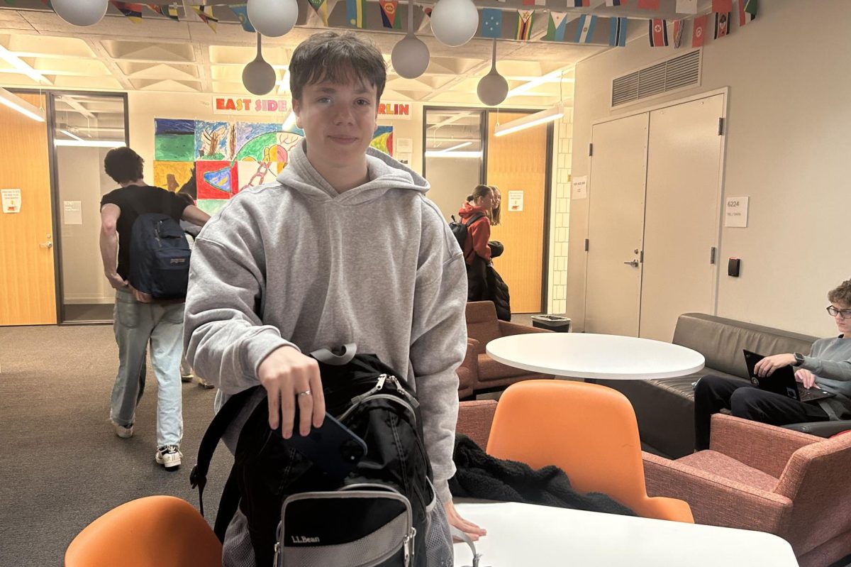 PHONE FREE FRIENDS. Sophomore Archie Dougherty places his phone in his bag. Putting the phone away before socializing, whether in your bag or pocket, is a great way to prevent endless scrolling. Giving your full presence to a conversation is an admirable gift.
