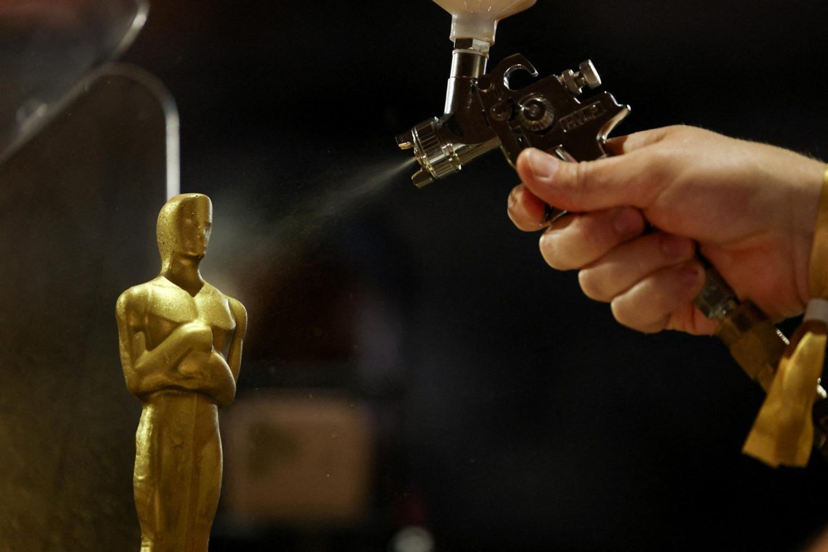 CEREMONY READY. A person spray paints an Oscar-shaped chocolate statue during a media preview of the food, beverages and decor for this year's Governors Ball, the official post-Oscars celebration of the Academy of Motion Picture Arts and Sciences (AMPAS), ahead of the 98th Academy Awards ceremony in Los Angeles, California, U.S., March 10, 2026. REUTERS/Mario Anzuoni