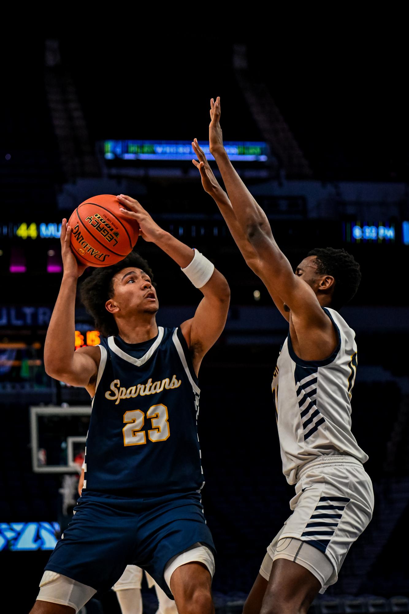 Senior Ezra Cunningham aims to shoot a basketball during a game at the Target Center. 