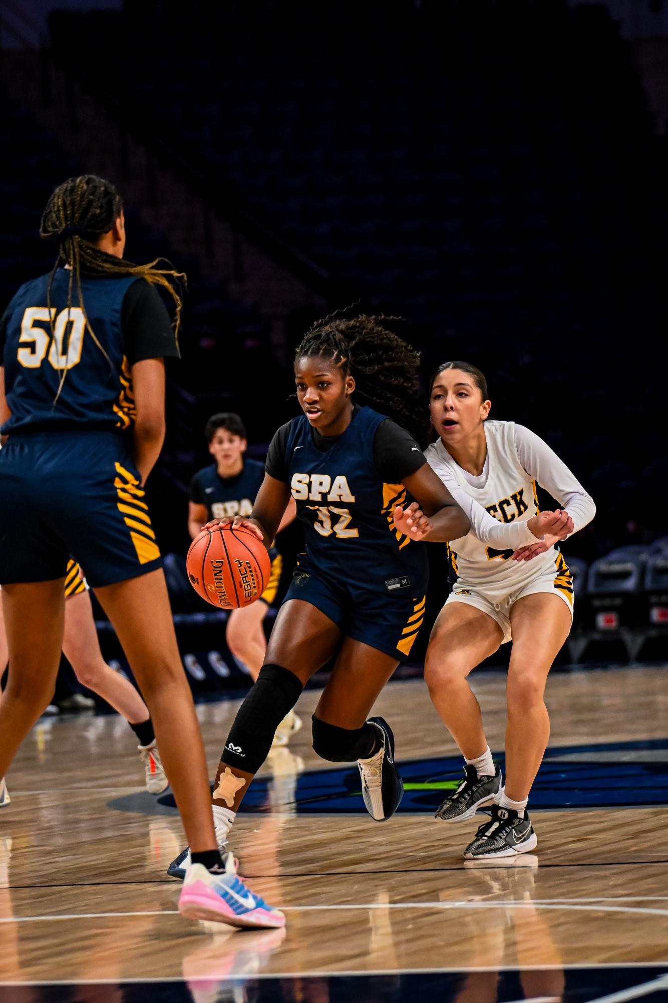 Eighth-grader Amaya Obi-Walker dribbles a basketball during a game at the Target Center. 