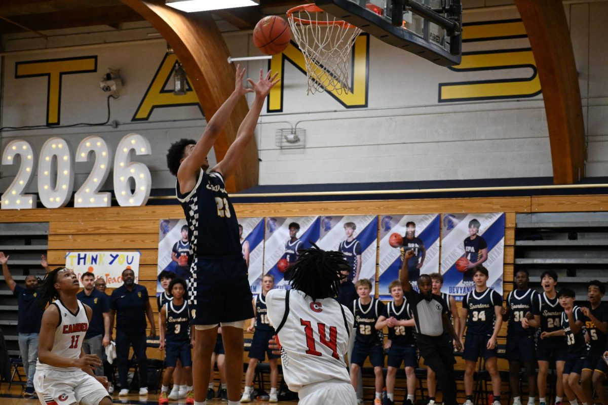 EPIC PLAYS. After a rebound off the backboard by senior Bokii Mullataa, senior Ezra Cunningham jumps for the ball it puts it in the basket.