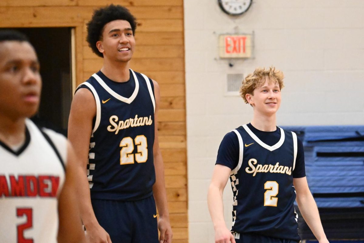 SENIOR SMILES. For the final free throw, senior Will Bogdan joins the game. Cunningham and Sieben cheer on and applaud Bogdan before he shoots successfully.