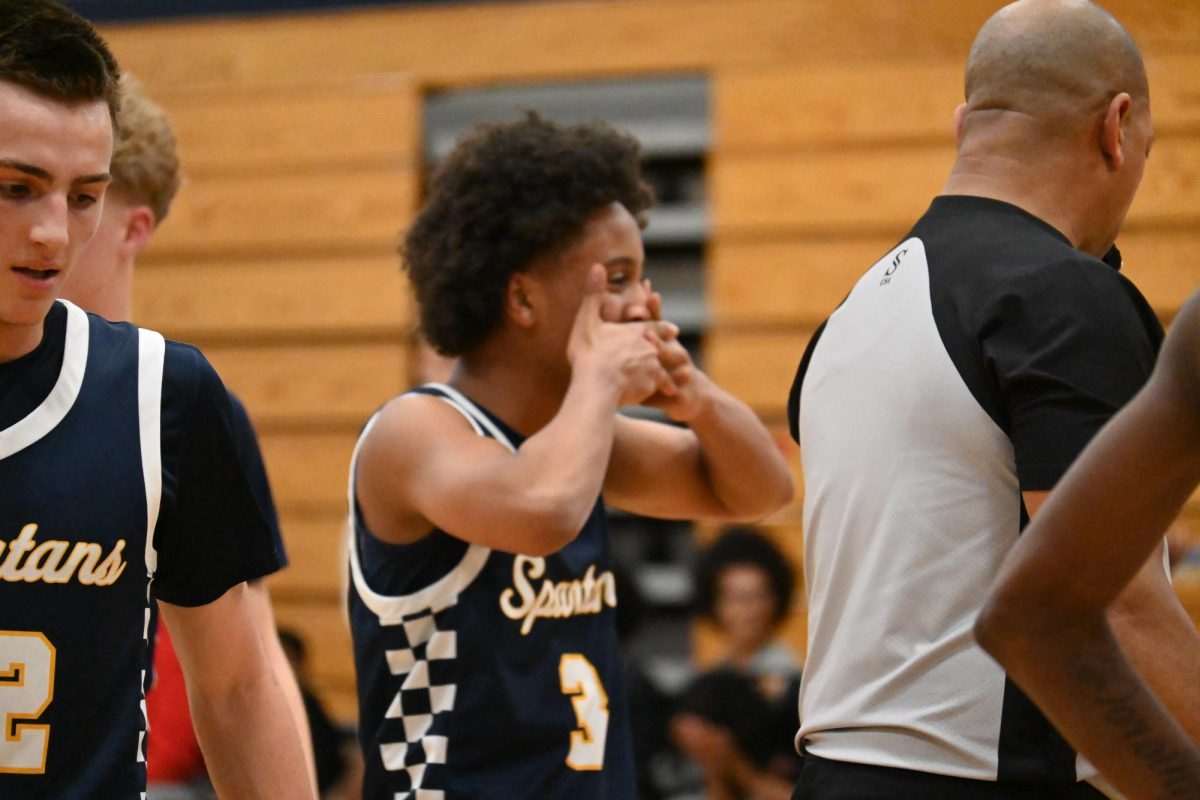 IN DISBELIEF. Freshman Magarsaa Mullataa scores a hard earned 3-pointer while on the ground, making one of the most memorable and exciting plays of the night.