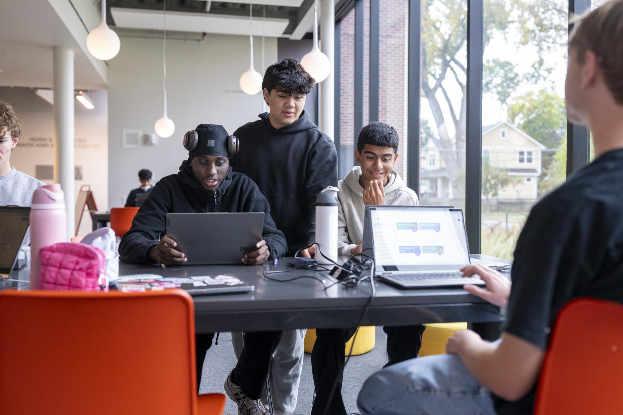 SMILES IN SCHILLING. Seniors LaRon Johnson, Will Bogdan and Ali Manzoor hang out in the lower Schilling commons during unscheduled time in the school day. “I’ve been trying to live in the moment a little bit more,” Johnson said about his final weeks of high school. (SPA Smug Mug)
