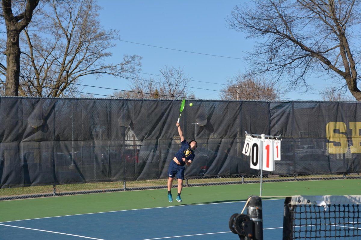 REFUSAL TO RELENT. No. 1 singles captain Allan Wang powers a serve across the net during his match against Edina. Despite falling behind one set and one game, Wang’s intensity remained high as he looked to break his opponent's momentum and spark a comeback.