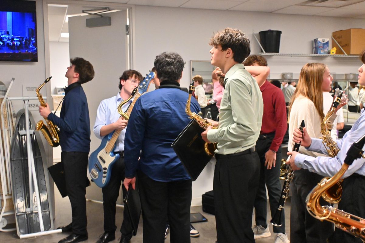 WARM-UPS. Before they took to the stage, the upper school jazz band tunes in the makeup rooms backstage.