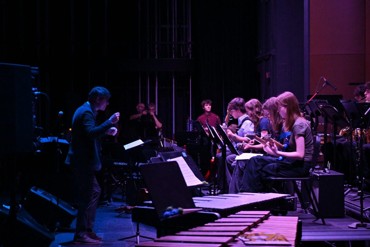 LEADING THE BAND. MS/US jazz band director Jack Breen pushes the band forward during "Red Clay."