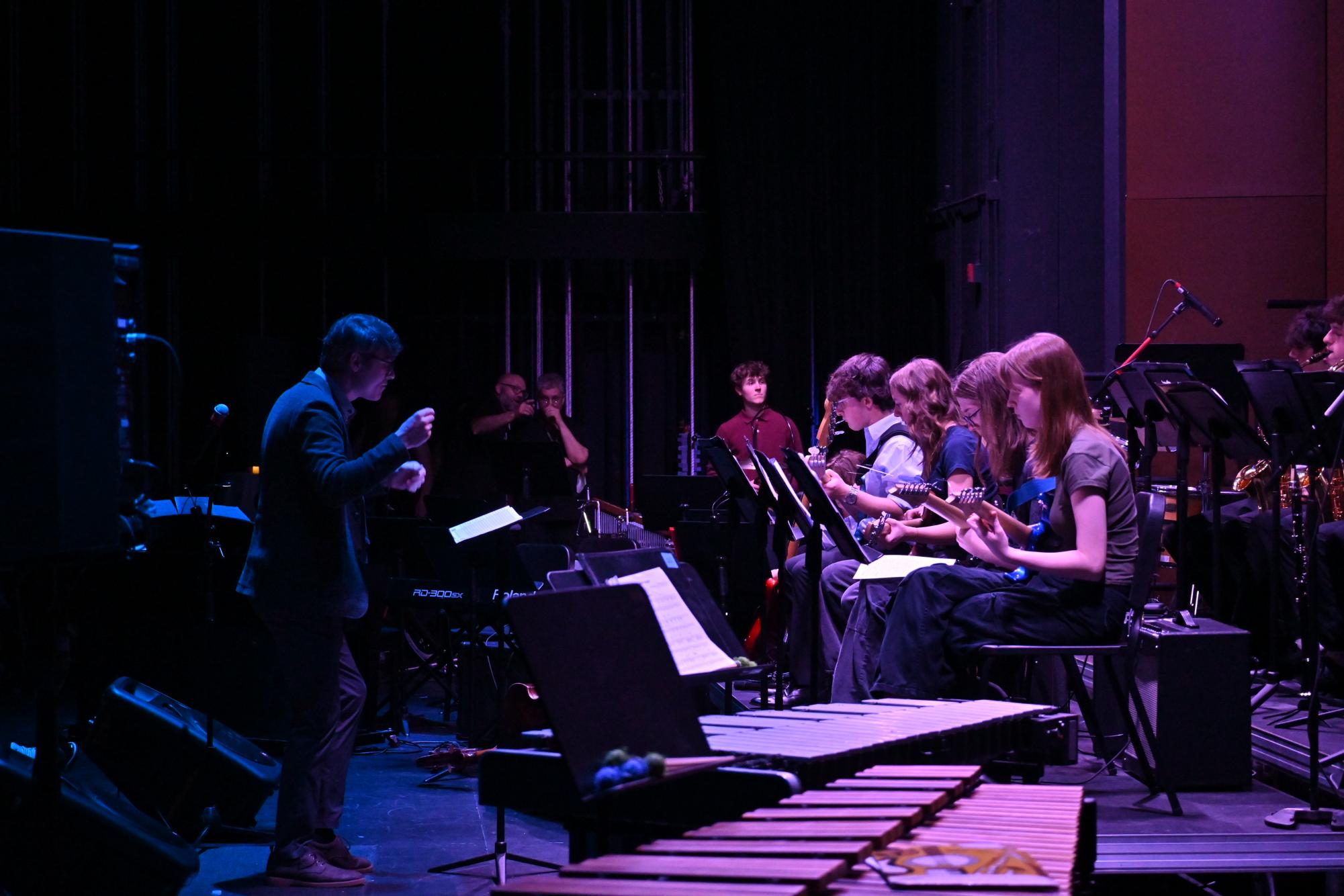 LEADING THE BAND. MS/US jazz band director Jack Breen pushes the band forward during "Red Clay."