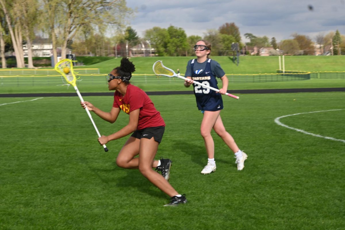 STICKING TOGETHER. The girls lacrosse team practices using drills to get control of the ball.