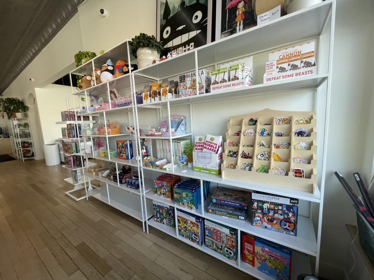 COLLECTIONS. On the rightmost side of the store, a large shelf contains various kinds of stickers, puzzles and blind-box collectibles. On her trip to Moona Moono, Sophomore Mae LaChance was drawn to this section of the store.