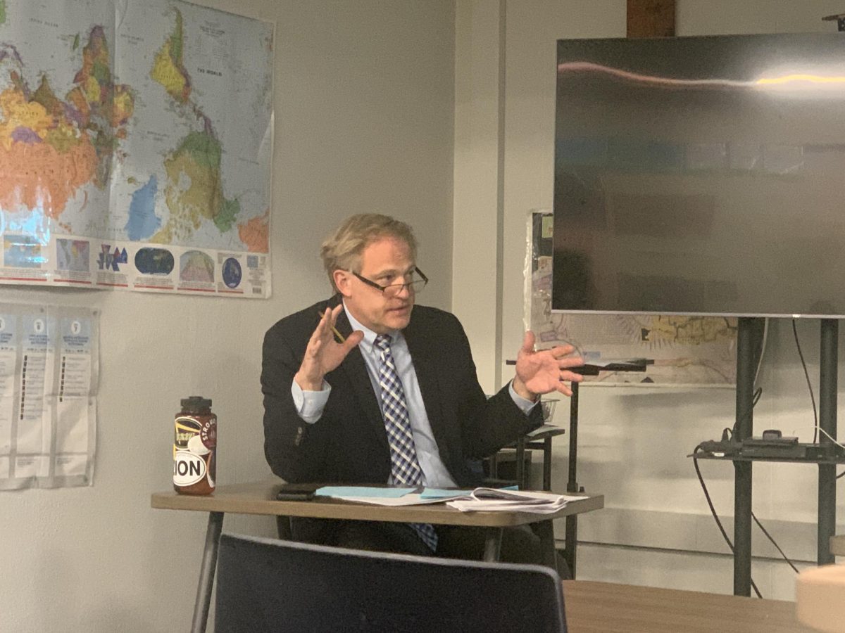 ENGAGING THE ROOM. History teacher Jon Peterson speaks during a panel session at the Advanced History Research Conference held at St. Thomas Academy on April 7. 