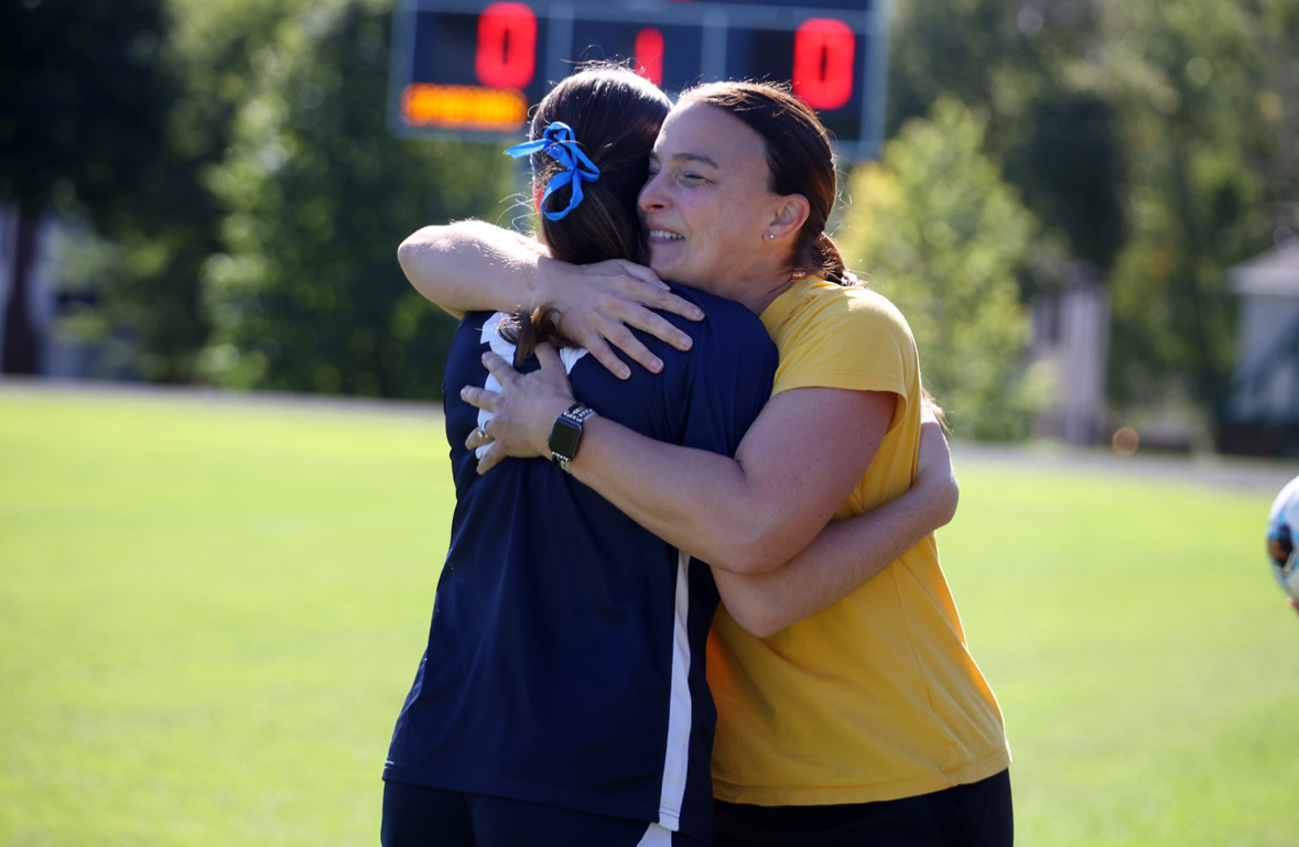 KICK OFF. Coach Jansen hugs Senior Clare Ryan Bradley after her Senior Night kick-off.