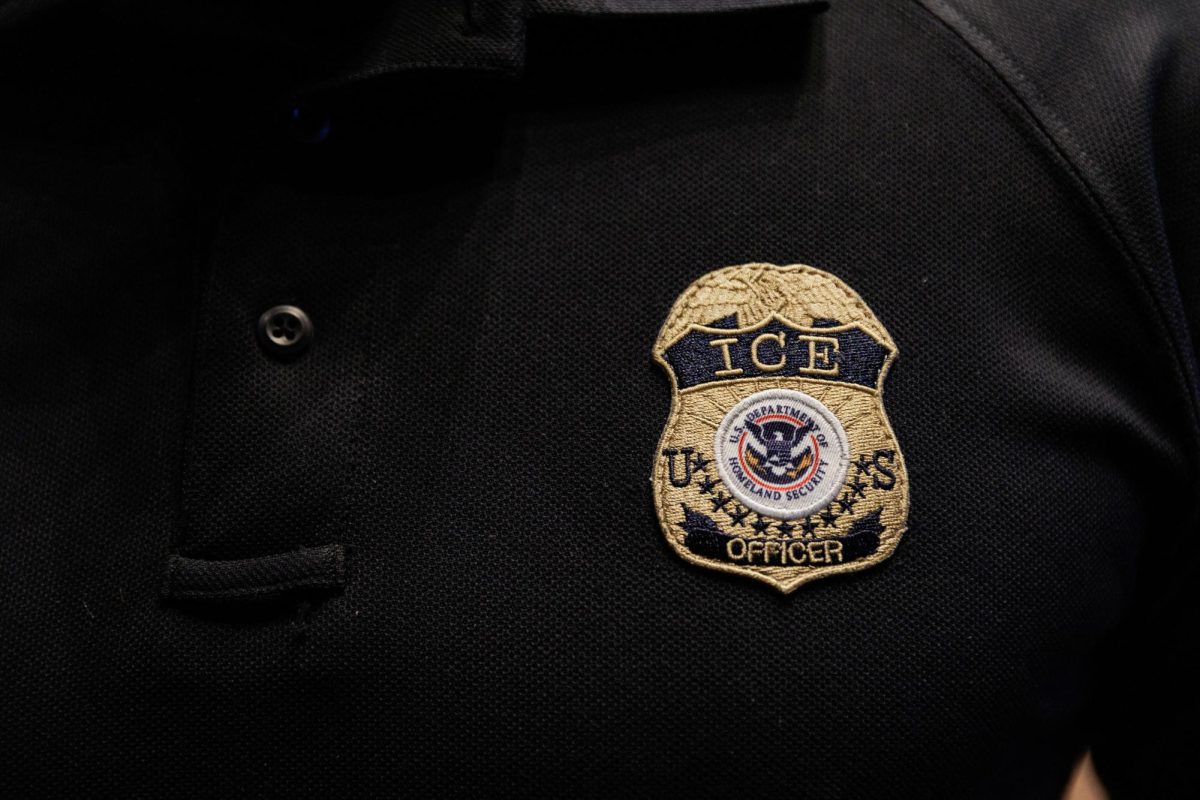 The badge of a U.S. Immigration and Customs Enforcement (ICE) is embroidered on a polo shirt of an ICE employee, in Arlington, Texas, U.S. August 26, 2025.  REUTERS/Shelby Tauber