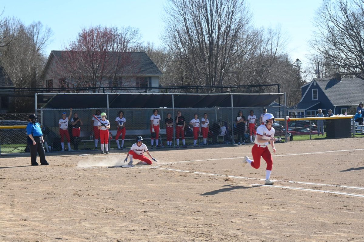 BRINGING IT HOME. Seventh grader Sabina Good slides into home base as tenth grader Zoe Wagner runs to first. The two Spartans were major contributors to the teams success in Wednesday's game.