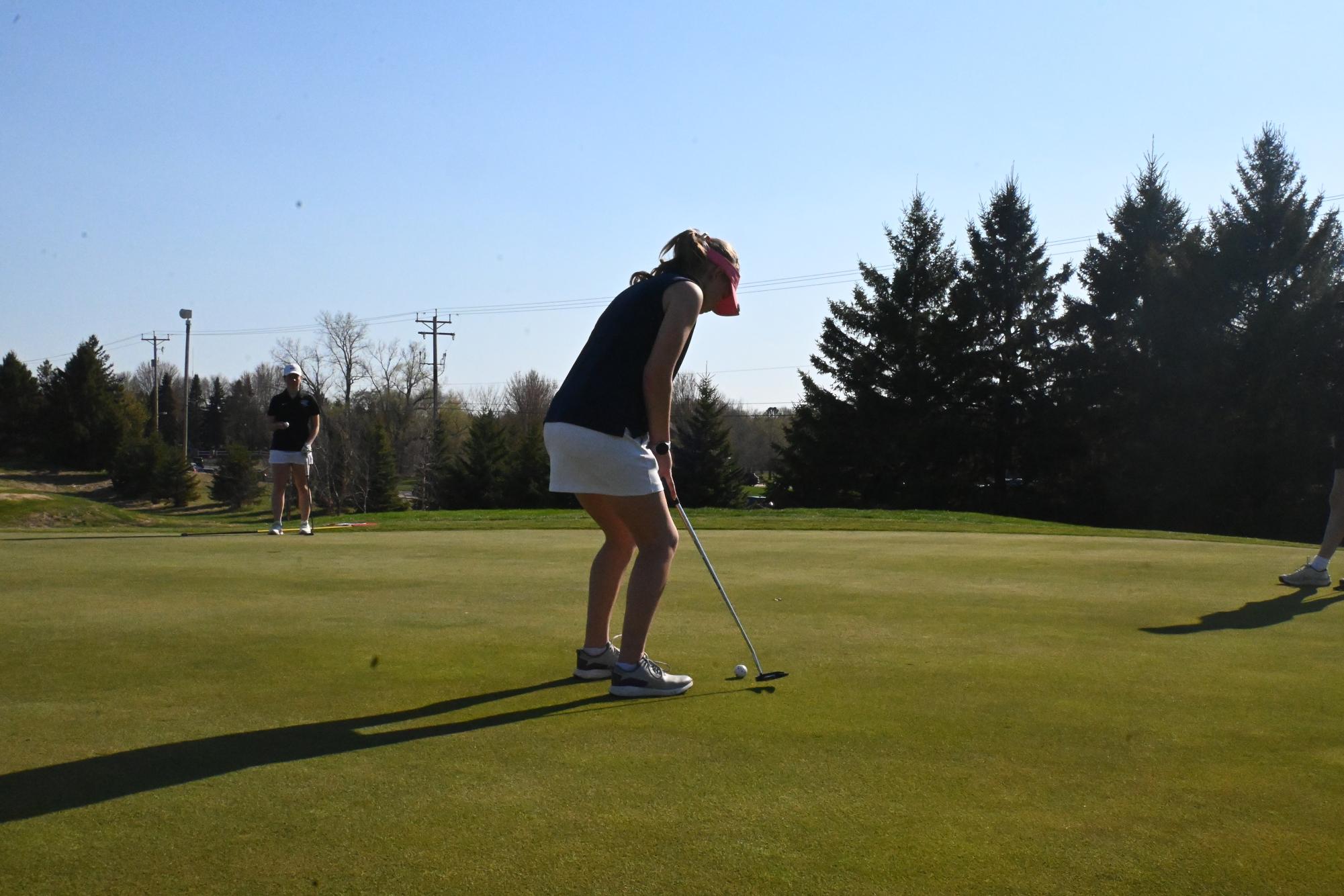 PERFECT PUTT. Girls golf captain Alyda Overgaard lines up her shot during practice. 
