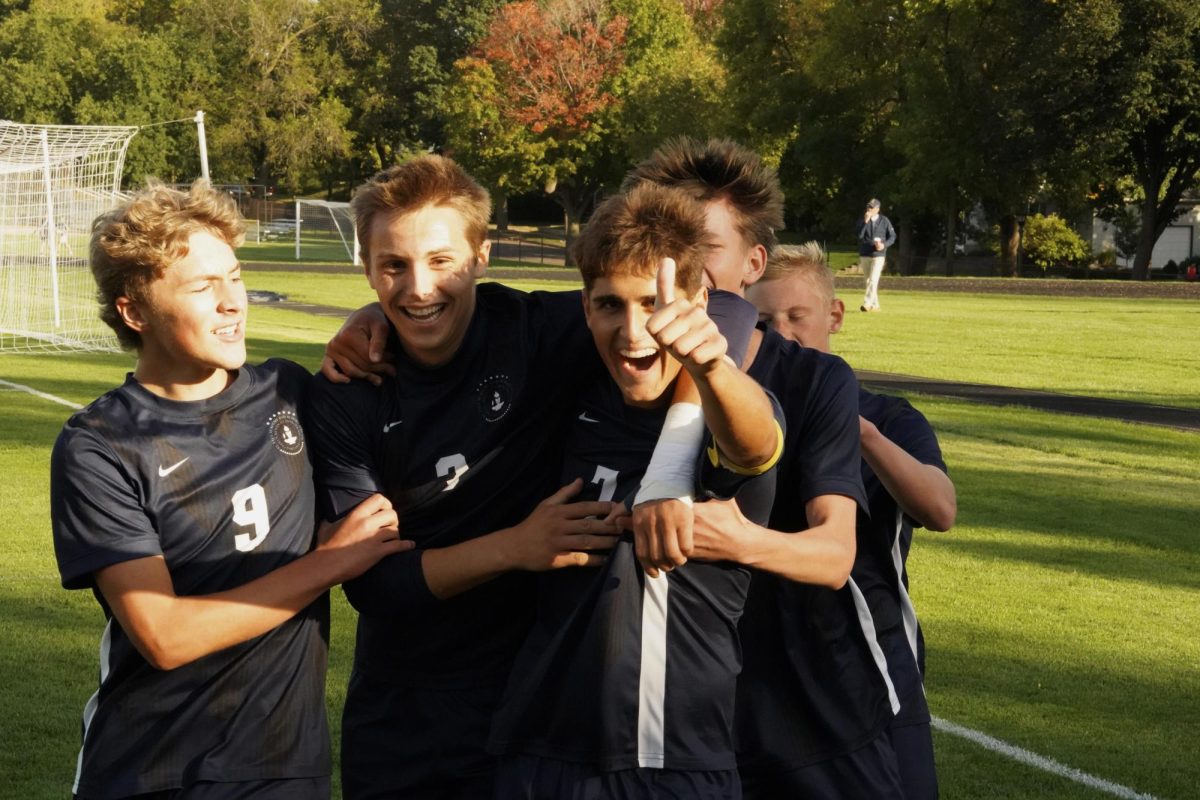 GOOD GOAL. Players Erik Bjorgvinsson, Brooks Geiger and Andrew Sullivan collectively celebrate after Bjorgvinsson scores in sections.