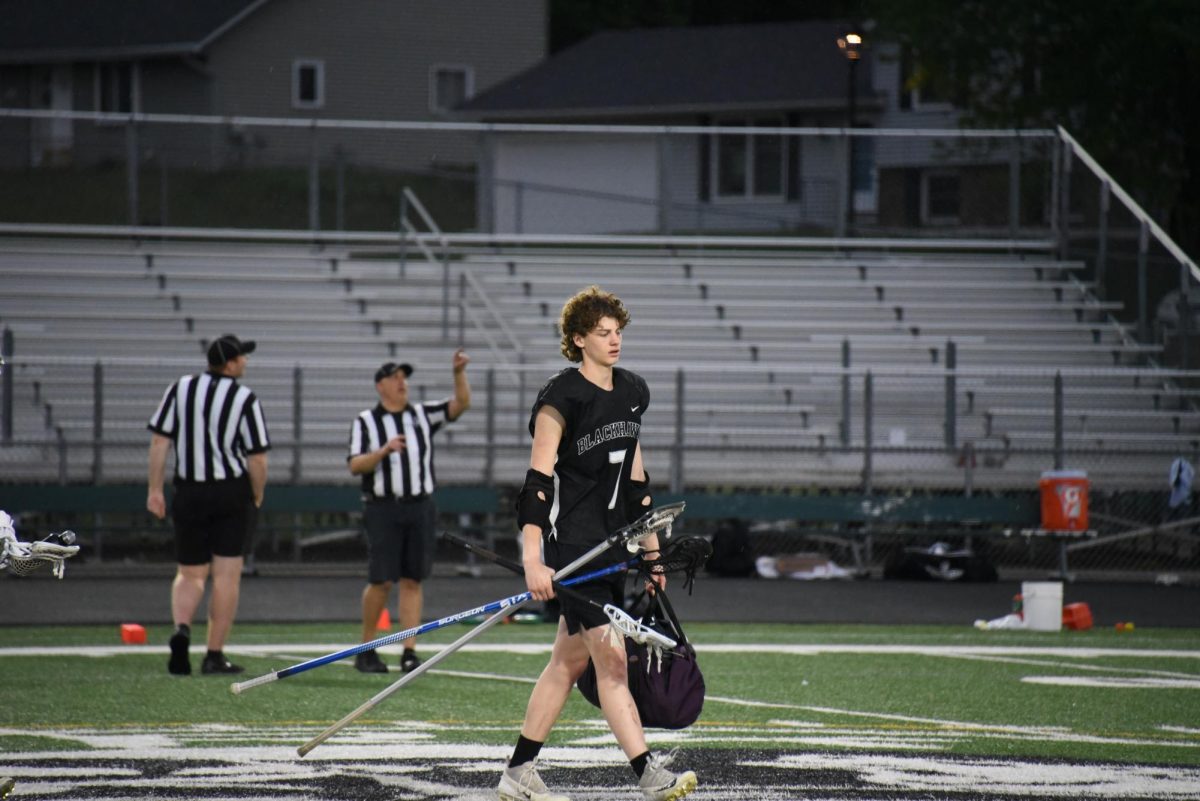 SEEK SHELTER. Junior Lachlan Gaspard gathers his equipment halfway through the game as thunder and lighting strike nearby. The game undergoes a 30 minute break to wait out the lighting for safety concerns.