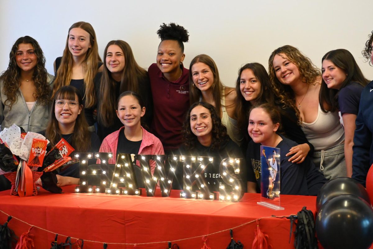 CELEBRATE. Dia Chaney's lacrosse teammates surround her for a picture after her signing.