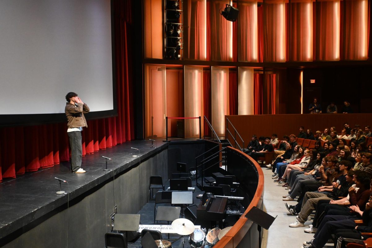 SPARTANS RALLY. Junior Richard Romans leads the auditorium through the Spartan beat in his speech to be elected as Spartan. The role of Spartan was newly added to USC elections this year.
