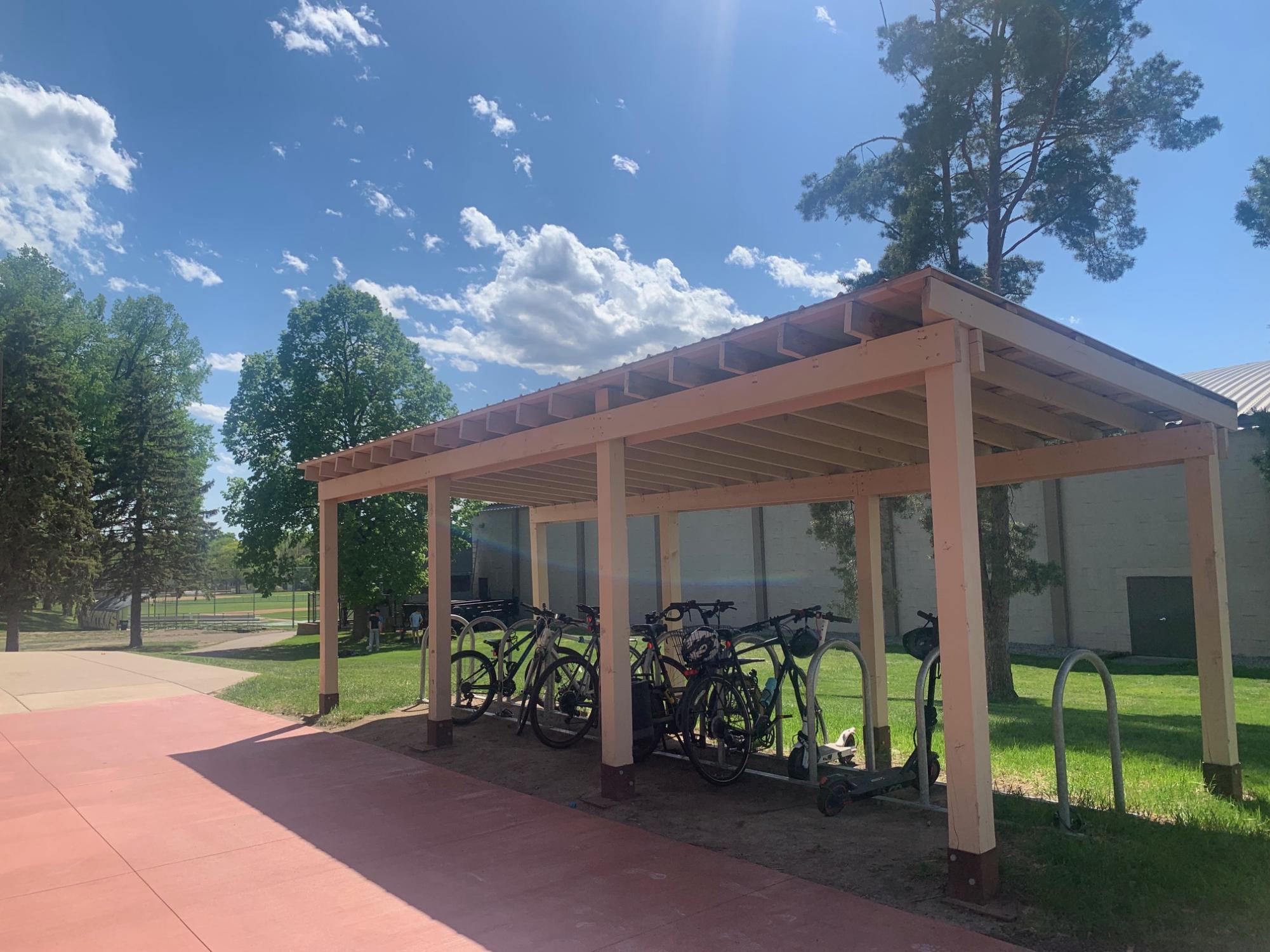BIKE-FRIENDLY. Bicycles and scooters sit beneath the covered bike racks outside SPA during National Bike to Work Week. History teacher Ben Bollinger Danielson said the additions have helped make campus more accommodating for cyclists. “I think it’s gotten to be more bike friendly,” he said. “I’m really happy that they put sort of a cover, a roof over the bike racks.”