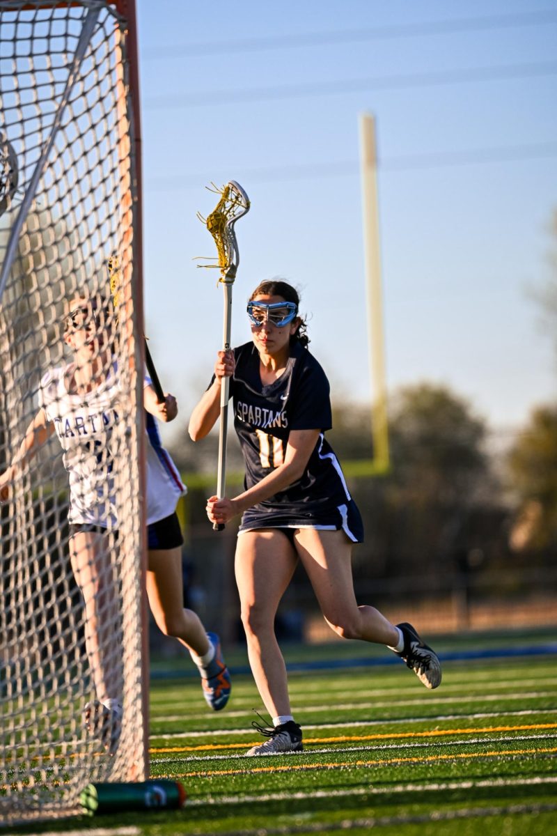 DIA DRIVES. Senior captain Dia Chaney drives towards the net in an attempt to score during the team's game against Tartan High School. The final score was 21-3 and the Spartans won their season opener. 
