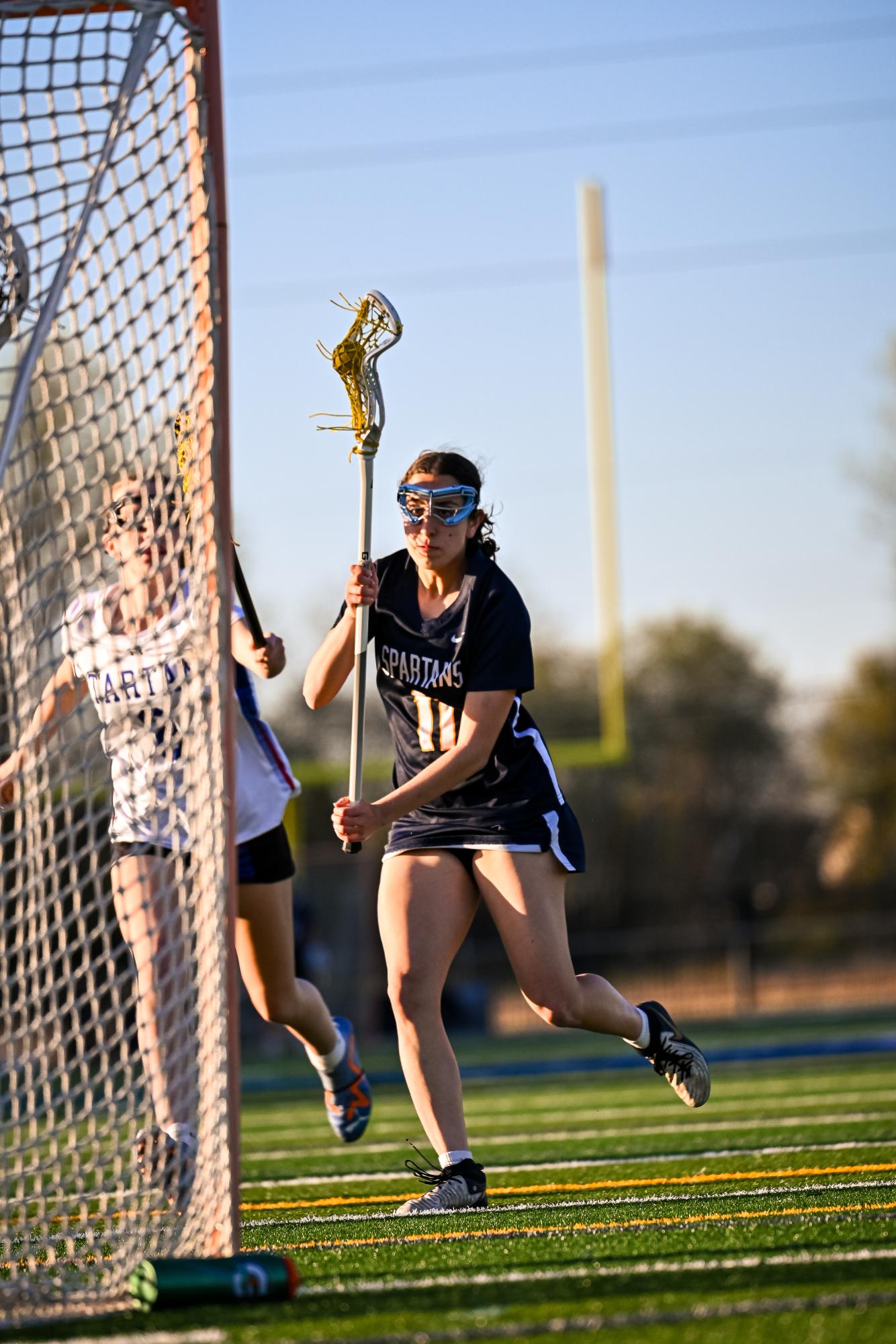 DIA DRIVES. Senior captain Dia Chaney drives towards the net in an attempt to score during the team's game against Tartan High School. The final score was 21-3 and the Spartans won their season opener. 
