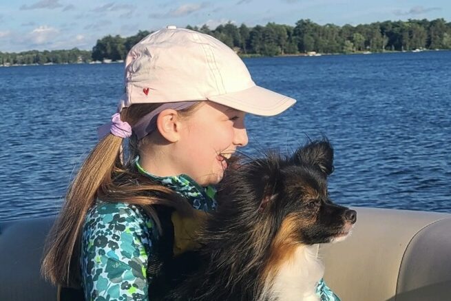 LAKEHOUSE LESSONS. Sophomore Gwen Uhlhorn enjoys a boat ride on the lake with her dog, Cedric. (Photo submitted by Gwen Uhlhorn)